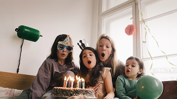 Family celebrating a birthday together at home symbolising personalised smart fridge features	