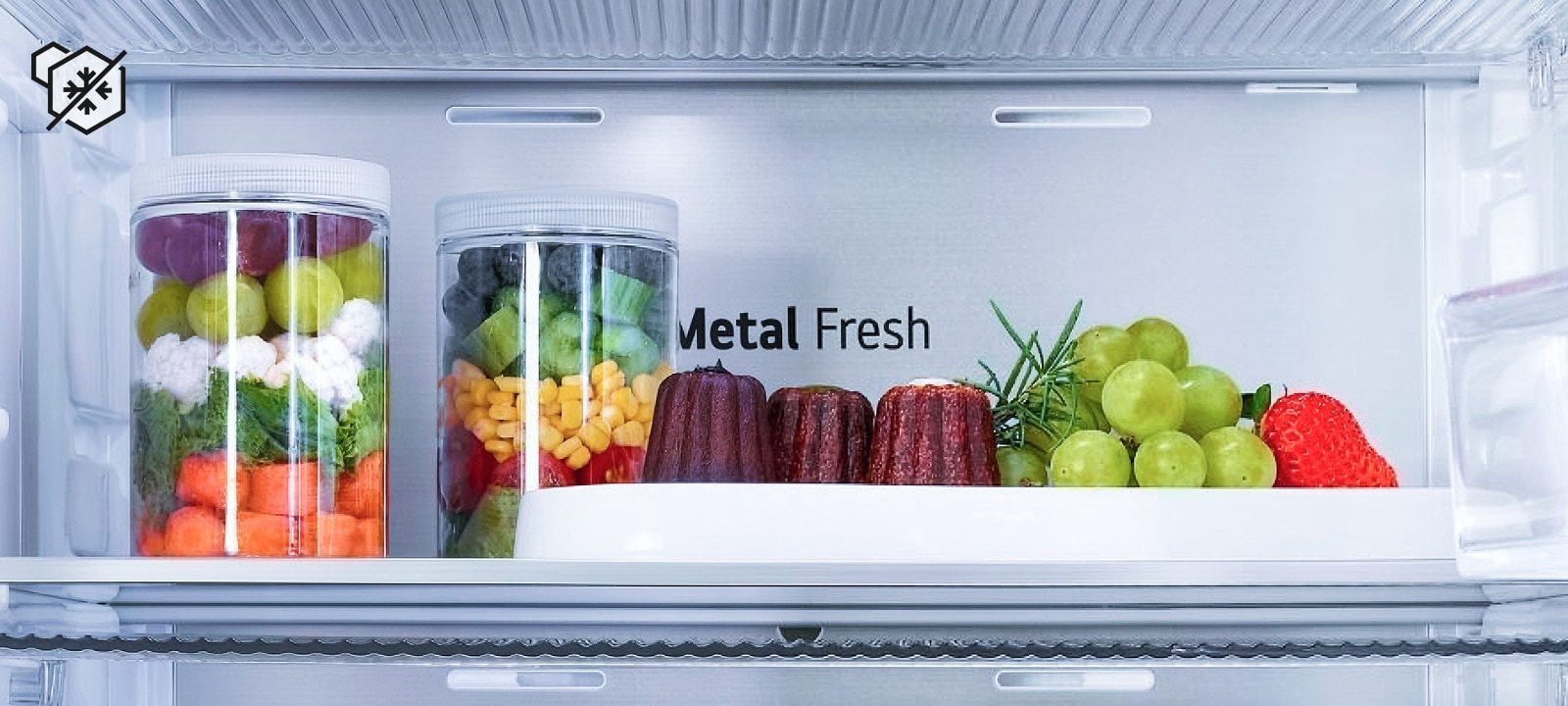 Close-up of LG fridge Metal Fresh™ freezing technology with fresh vegetables and desserts kept frost-free on one side and icy on the other, highlighting freshness.