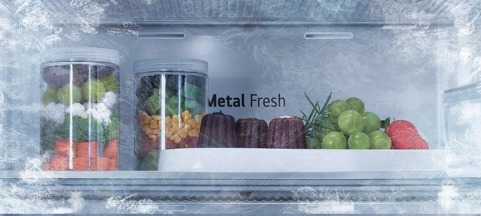 Close-up of LG fridge Metal Fresh™ freezing technology with fresh vegetables and desserts kept frost-free on one side and icy on the other, highlighting freshness.