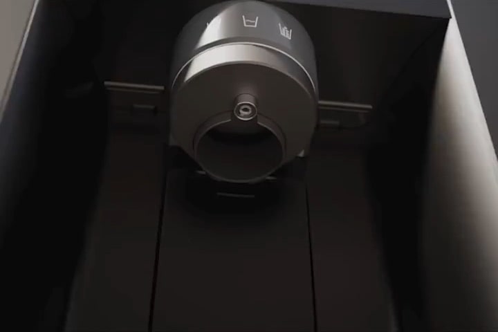 Close-up of the LG refrigerator’s ice and water dispenser nozzle, showing sterilised interior as clean water flows out.