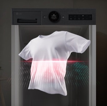 A red laser shines through a white T-shirt in the foreground, while a black LG washing machine stands in the background.