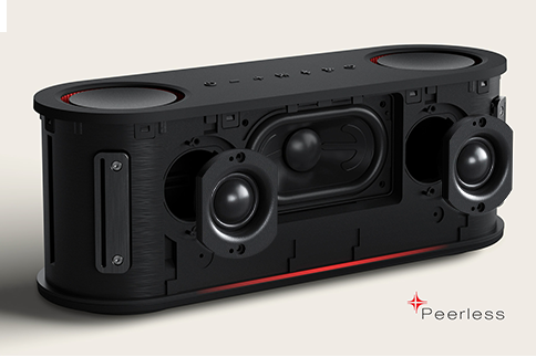 Woman sits indoors relaxing with LG Speaker