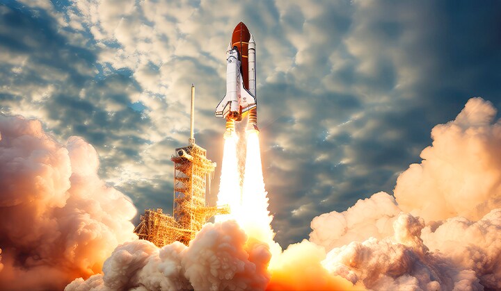 Parts of an image can be seen inside the silhouette of a giant 3X text. As the text gets bigger, a space shuttle launch can be seen. As the text expands to beyond the screen, the full content is revealed. The visual then gets enhanced from top to bottom to be brighter and more vibrant.
