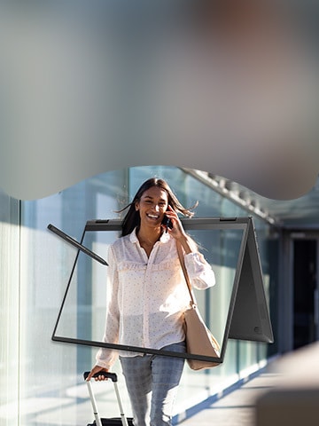 Woman taking mobile telephone call at airport. There is an LG gram 2-in1 laptop with stylus displayed on the image. 