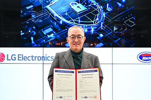 LG Electronics executive holding certificate of accreditation for cybersecurity, with digital security graphic in background