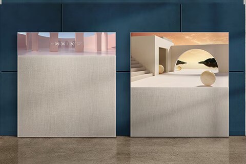 An image of two LG OLED Easel TVs against a navy blue wall. One is in Line View, showing the time and weather information. The other is in Full View, with artwork displayed on screen.	