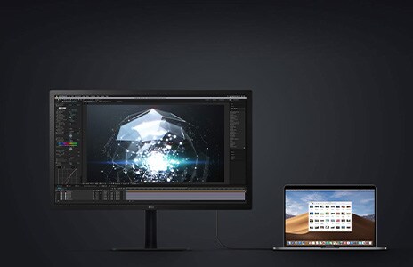 Monitor paired with laptop in dark room showcase refined display