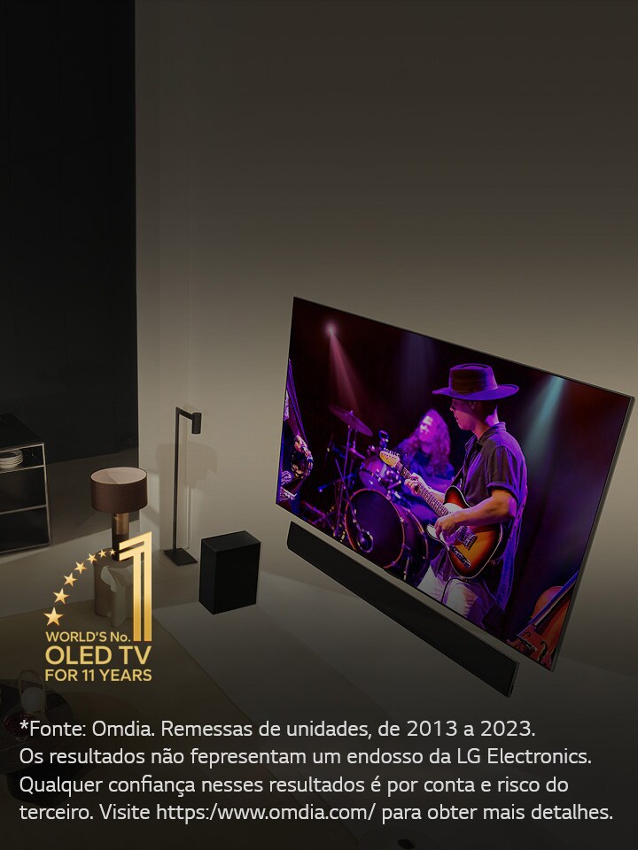 Uma perspectiva aérea de um homem e uma mulher assistindo a um concerto em uma grande TV OLED em um apartamento moderno. O emblema “A OLED TV número 1 do mundo por 11 anos” é exibido na imagem. Um aviso diz: “Fonte: Omdia. Remessas de unidades, de 2013 a 2023. Os resultados não representam um endosso da LG Electronics. Qualquer confiança nesses resultados é por conta e risco do terceiro. Visite https://www.omdia.com/ para obter mais detalhes.”