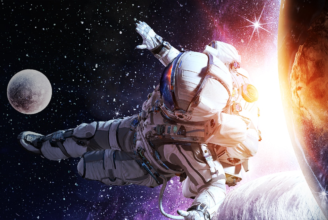 An astronaut in a spacesuit floating in outer space with the Earth and stars in the background.