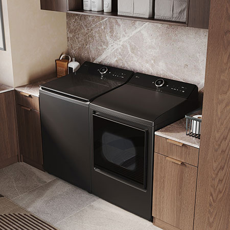The LG Top Load Washer and Dryer set (WT8600CB) in Black Steel, showcasing the flat-top design and premium finish integrated perfectly beneath the upper cabinetry.