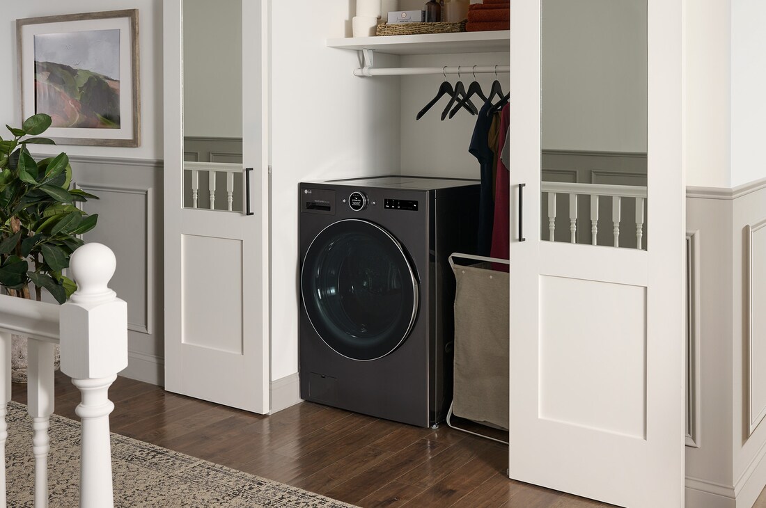The LG Front Load Washer Dryer Combo WM6998HBA in Black Steel, showcasing its space-saving all-in-one design and discrete installation within a fitted closet.