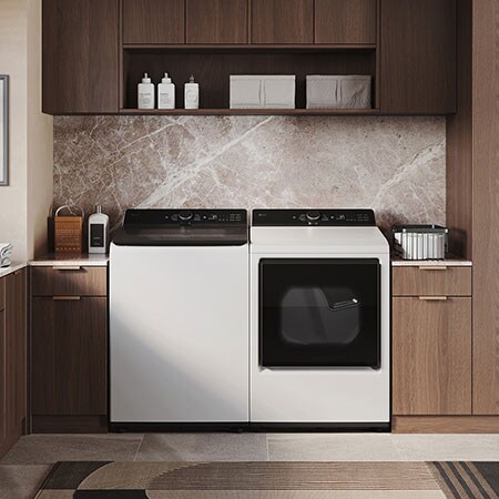 The LG Top Load Washer and Dryer set (DLE8400WE) in White, showcasing the flat-top design and clean finish integrated perfectly beneath the upper cabinetry.