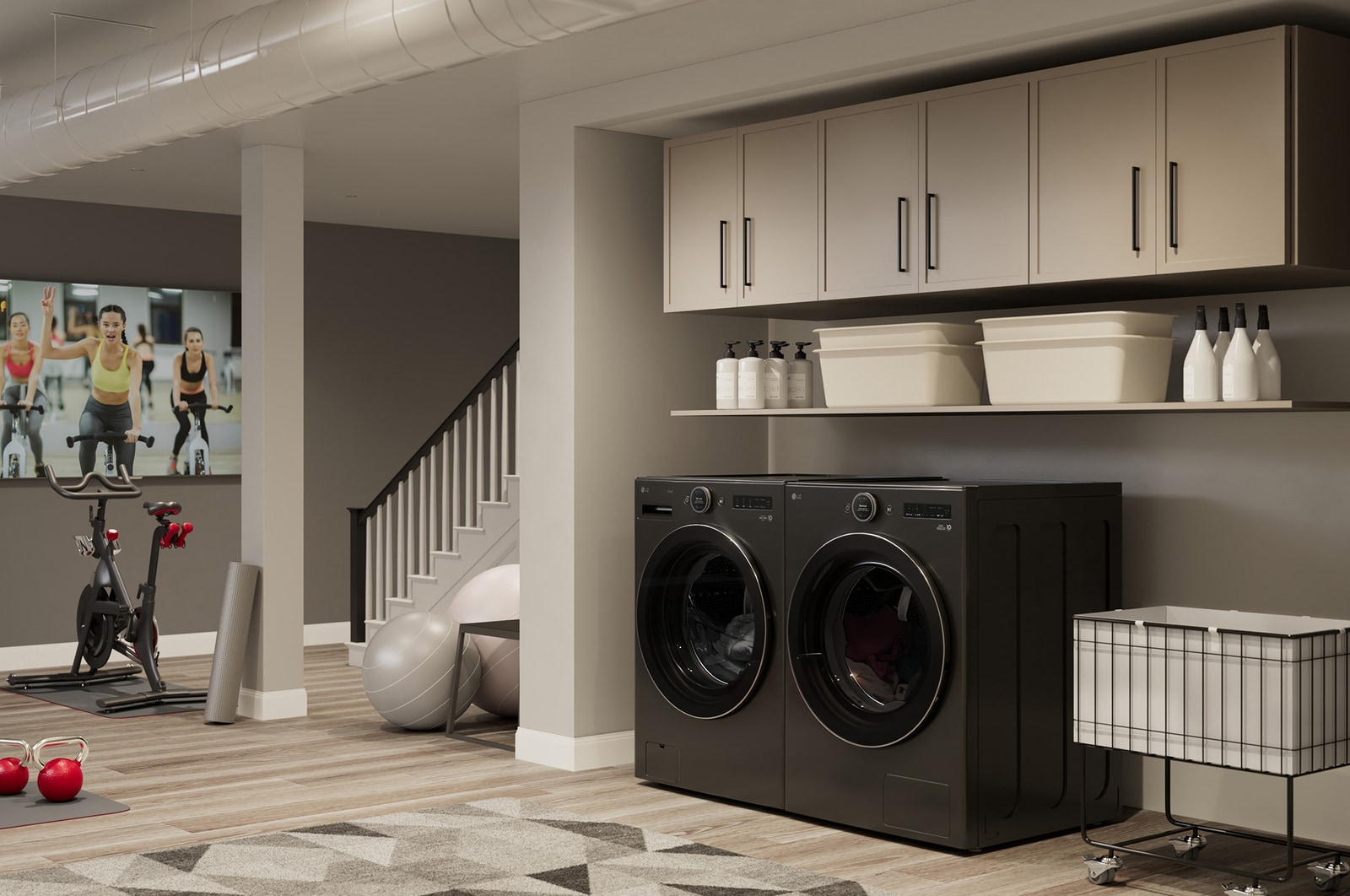 The LG Front Load Washer and Dryer set (DLHC6702B) in Black Steel, showcasing its premium aesthetic and seamless integration into a modern, multi-purpose utility and gym space.