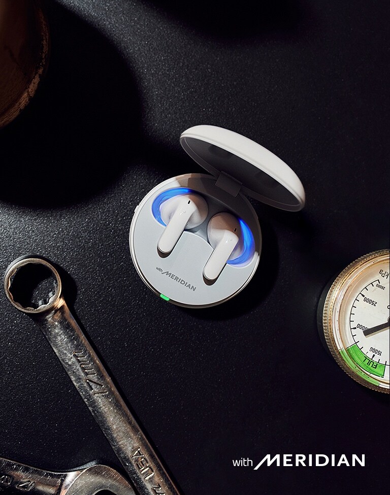 An aerial view of the T90 earbuds inside the cradle, sitting on a tabletop.