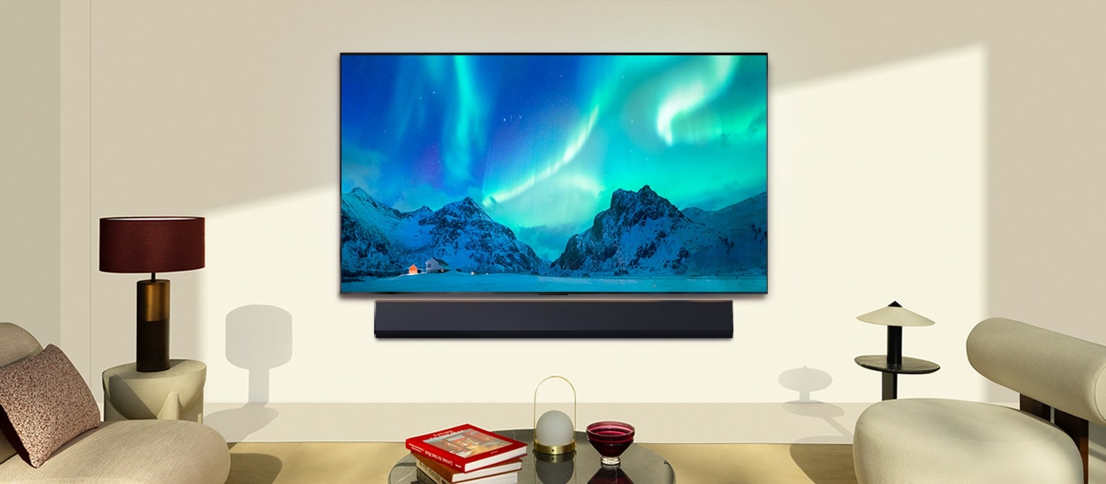 LG OLED TV and LG Soundbar in a modern living space in daytime. The screen image of the aurora borealis is displayed with the ideal brightness levels.