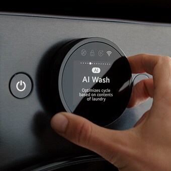 Hand adjusting AI Wash cycle on LG washing machine using smart control dial