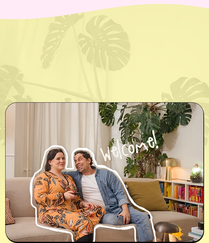 The couple is sitting on the sofa, watching TV.