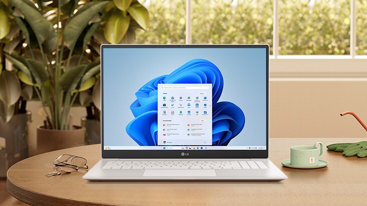 On the desk, there is an LG gram displaying the Windows 11 screen.