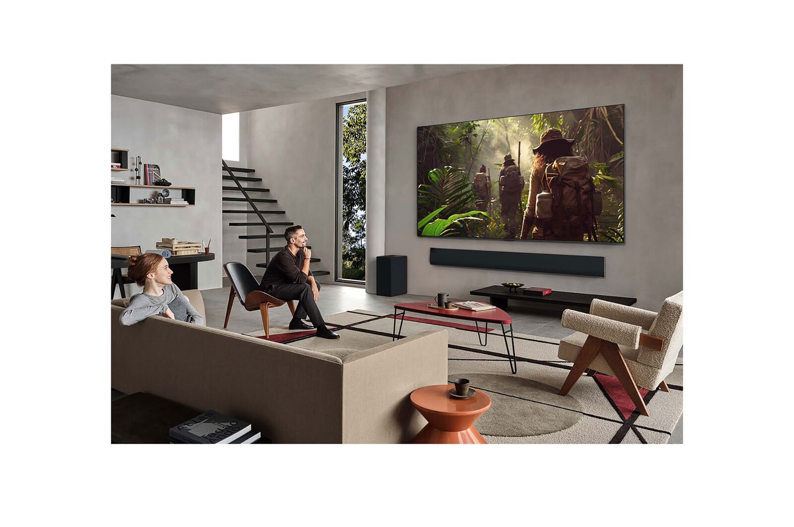 On an LG OLED TV screen is the webOS 25 home page filled with apps and entertainment content. By the TV is the LG AI Magic Remote, the AI button is highlighted as if activated by the user's voice. A speech bubble is beside it, switching to my account. The short text explains how users can now synchronize their voice to their personal profile for easier navigation and personalized recommendations.