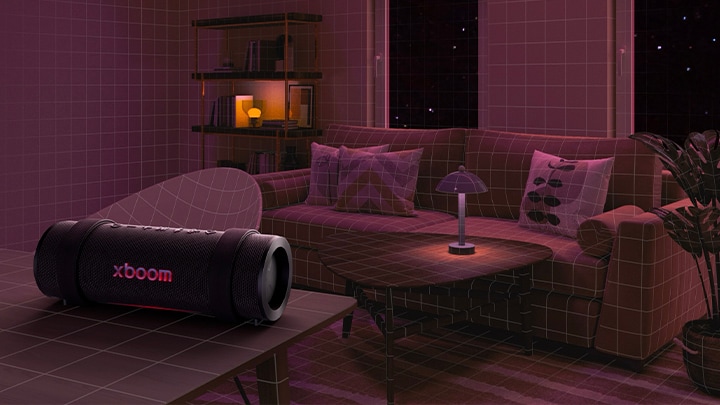 In einem Raum mit roter Beleuchtung stehen ein schwarzes Sofa, ein schwarzer Hocker und ein schwarzer Sessel. Im Vordergrund steht der xboom Grab auf einem schwarzen runden Tisch.