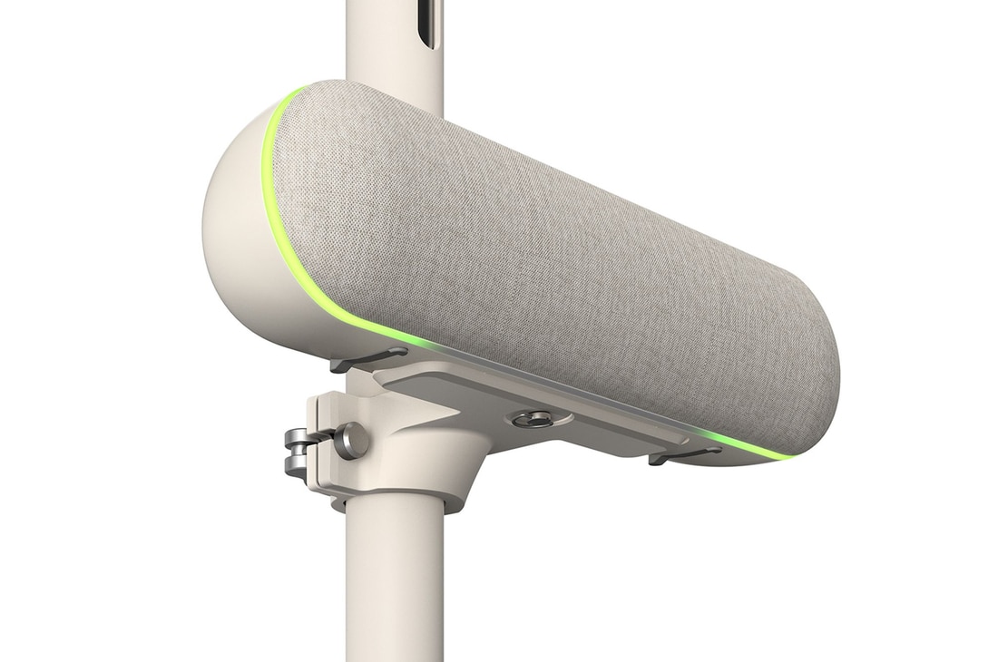 Close-up of the speaker with the left side facing forward attached to LG StanbyME. The green mood lighting is on.