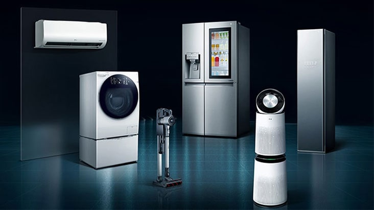 An air purifier, refrigerator, styler, washing machine, and vacuum arranged in a dark setting.