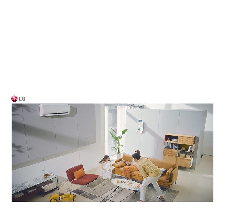 A family plays in a living room and the air condition sits in the top of the picture.