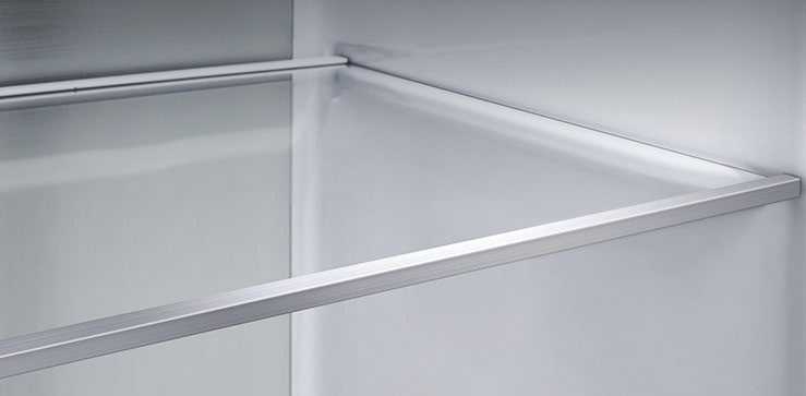 A diagonal view of the shelf with metallic paneling on the interior of the refrigerator.