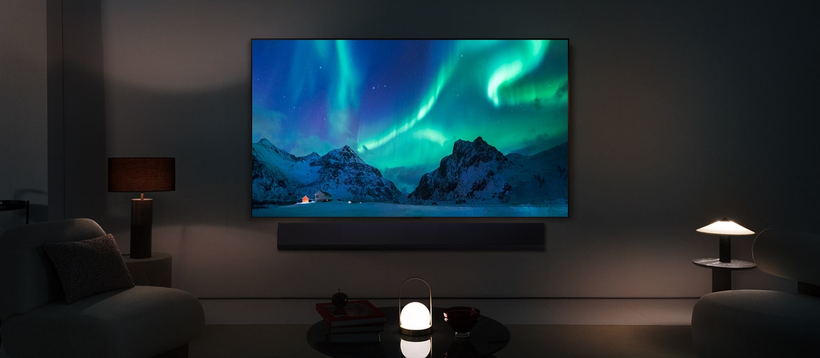 LG OLED TV and LG Soundbar in a modern living space in nighttime. The screen image of the aurora borealis is displayed with the ideal brightness levels.