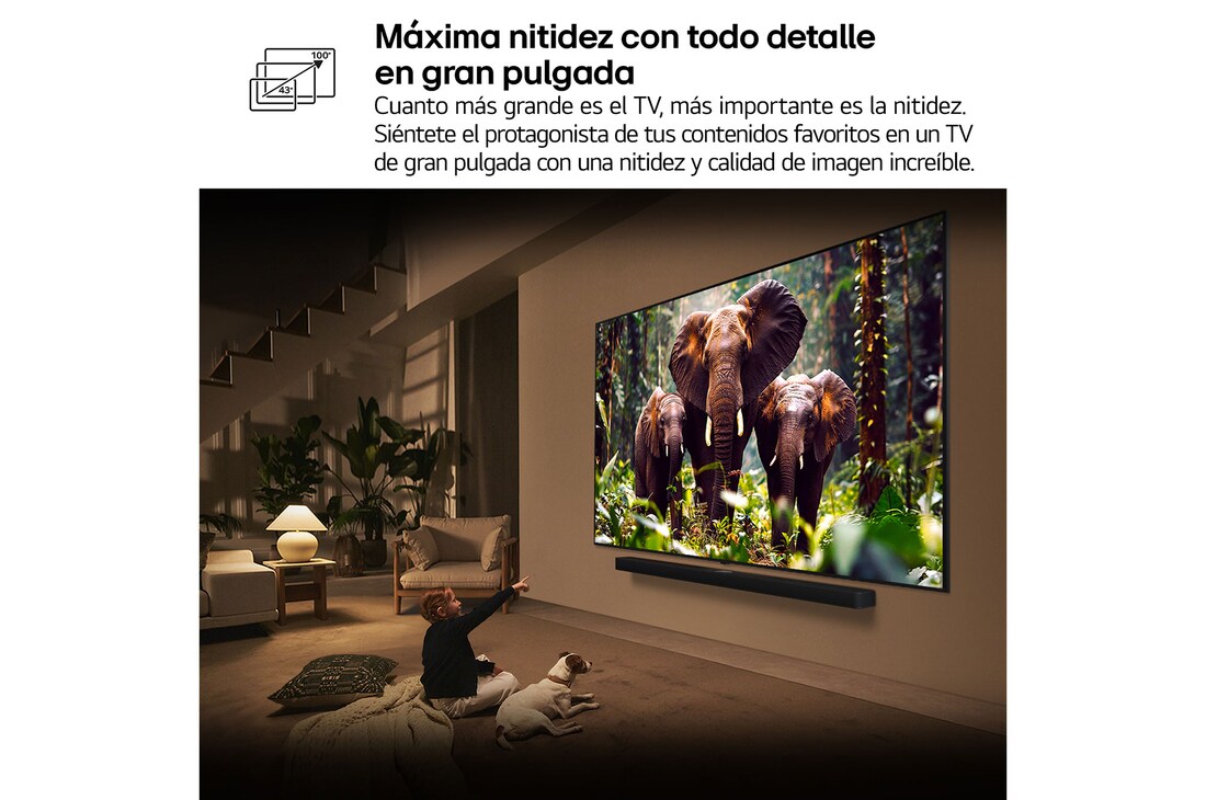 Una niña y un perro están sentados frente a un televisor LG QNED TV montado en una pared con una barra de sonido LG Soundbar. En pantalla muestra a tres elefantes caminando hacia adelante. El título hace referencia a cómo cada acción es más emocionante en una pantalla gigante.