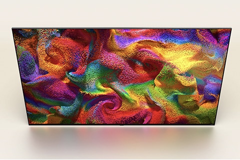 Vista aérea angular de un televisor LG QNED con una imagen abstracta y colorida en pantalla.