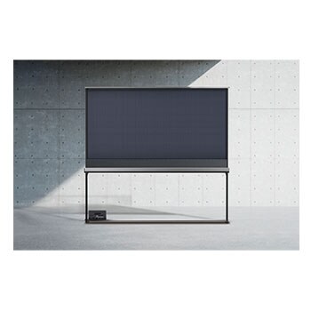Vue latérale d’une LG SIGNATURE OLED T avec le boîtier Zero Connect placé sur le sol juste en dessous. 