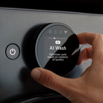Hand adjusting AI Wash cycle on LG washing machine using smart control dial