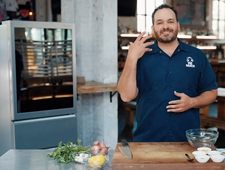 Matt Abdoo, chef and owner at pig beach, is standing next to LG SIGNATURE Wine Cellar.