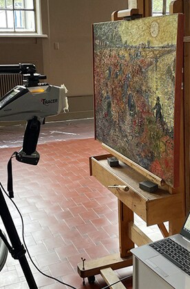 A machine scans The Red Vineyard at Arles.