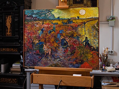 An image of The Red Vineyards at Arles on an easel.