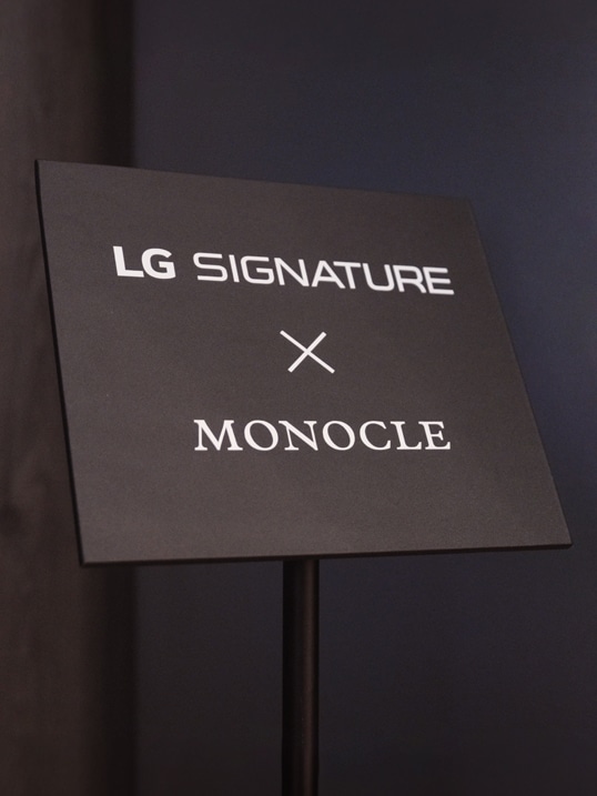 Floor standing sign in the LG SIGNATURE exhibition hall marked LG SIGNATURE X MONOCLE.