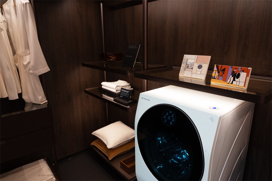 The LG SIGNATURE washing machine is showcased as part of an exhibition, shown placed in a closet space.