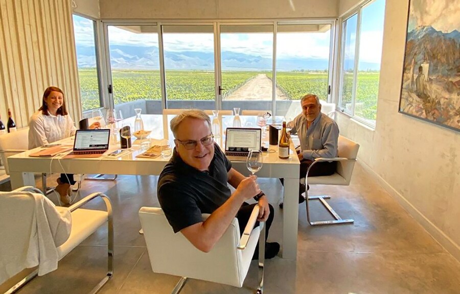 James Suckling and his friends are drinking wine in the living room.