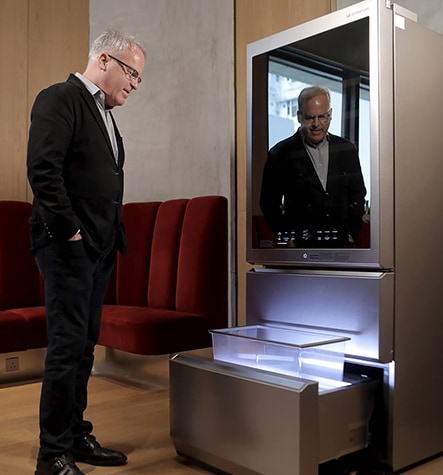 James Suckling is looking at the auto open drawer of LG SIGNATURE Wine Cellar.