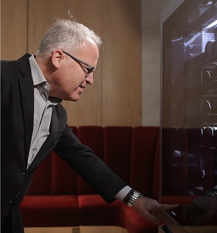 James Suckling is touching led glass display on the LG SIGNATURE Wine Cellar.