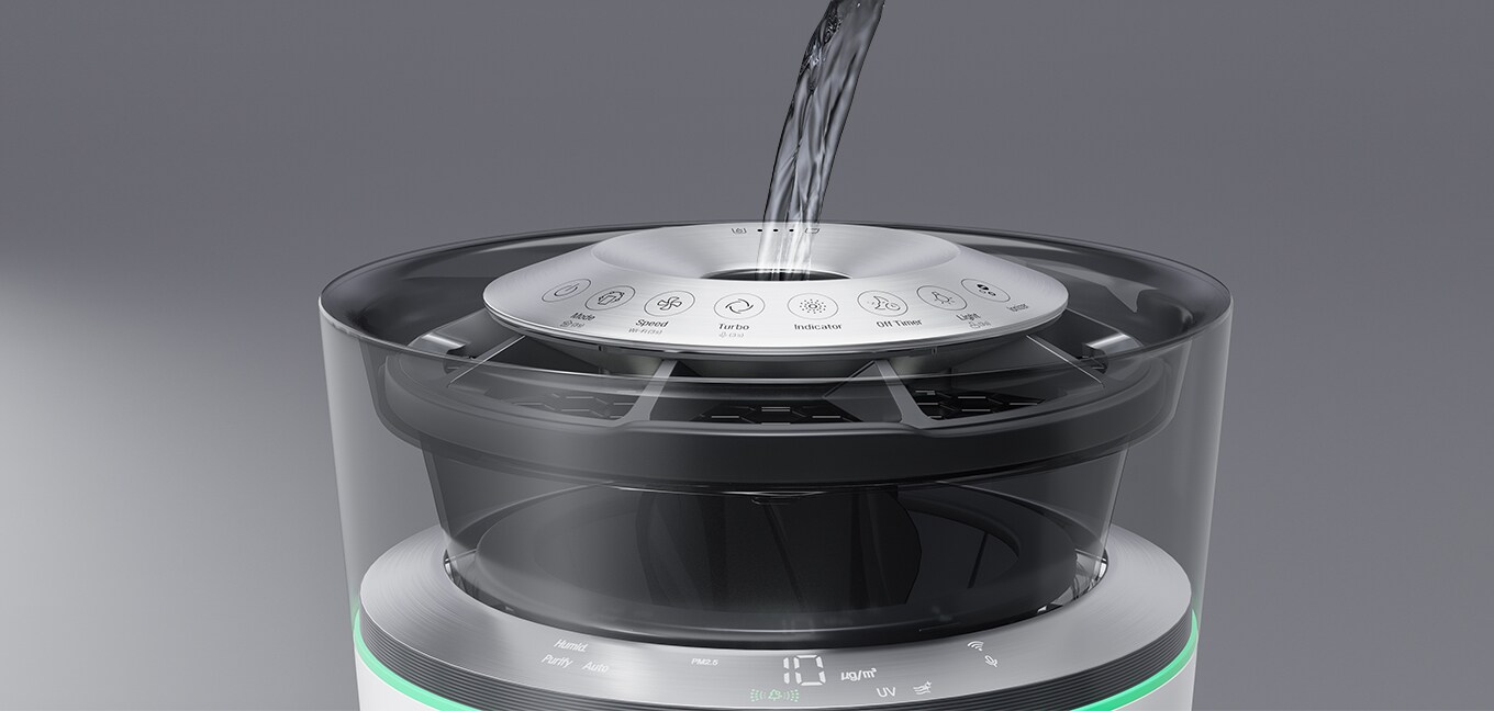 Water being poured into the opening on the top of the Air Purifier. 