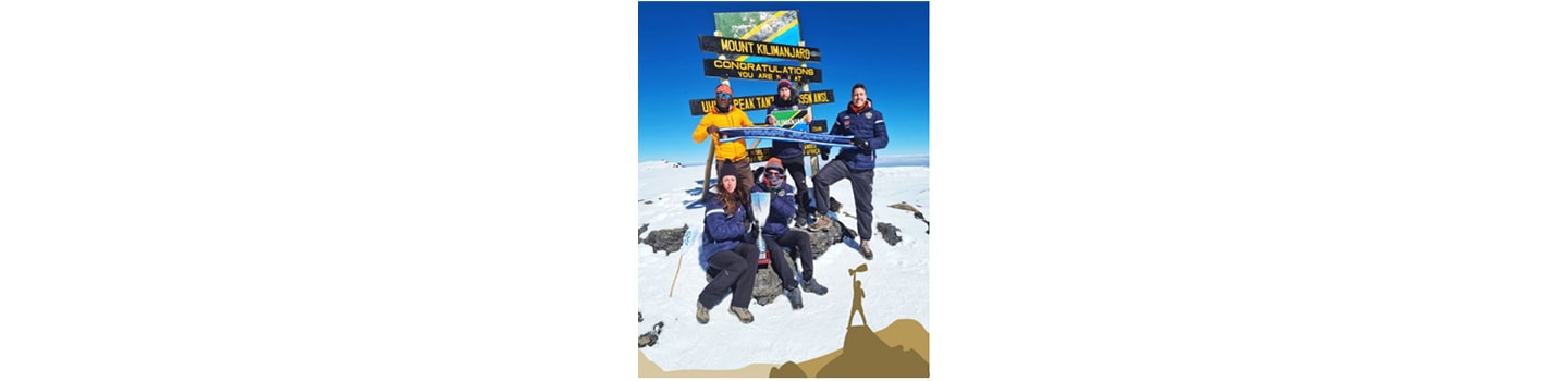 Members of FC Cambounet pose for a group photo at the peak of Mount Kilimanjaro.