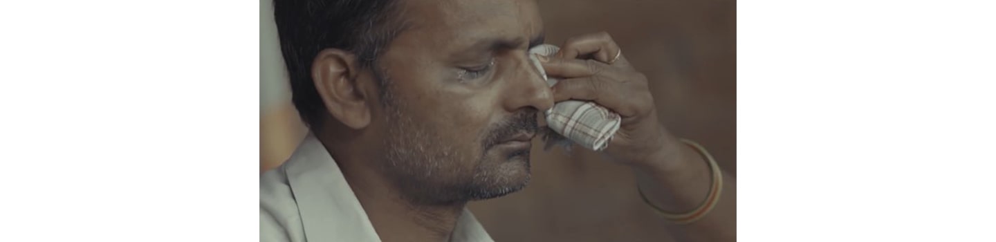 A man with a corneal disease is being treated by a medical professional