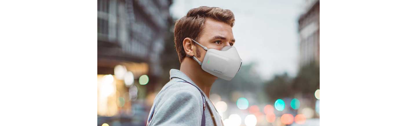 A man on a street wearing LG PuriCare wearable Air Purifier