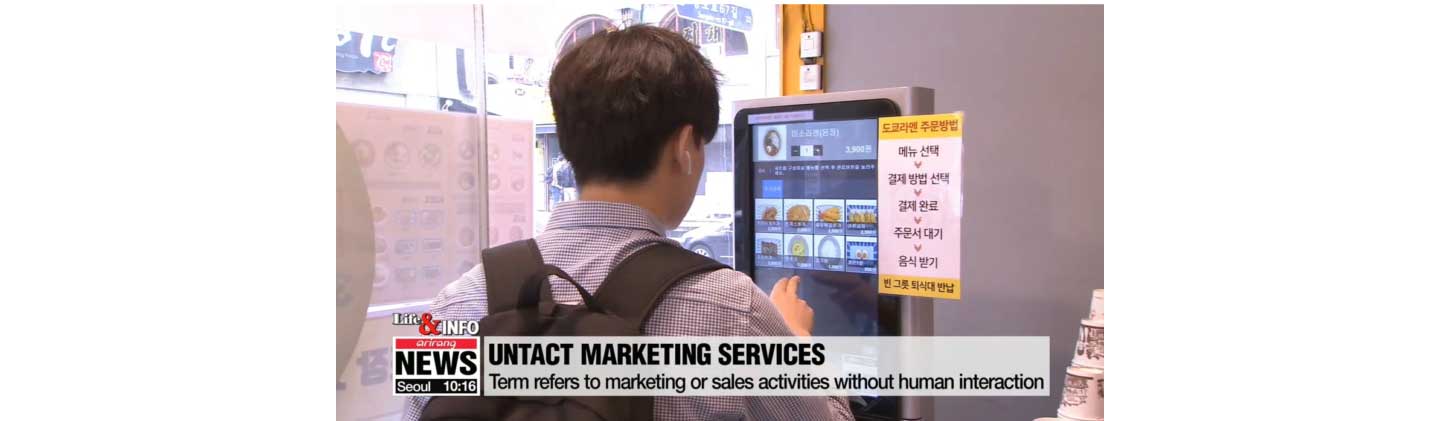 Untact marketing services at a restaurant, with a person placing his food order using a touch-screen device