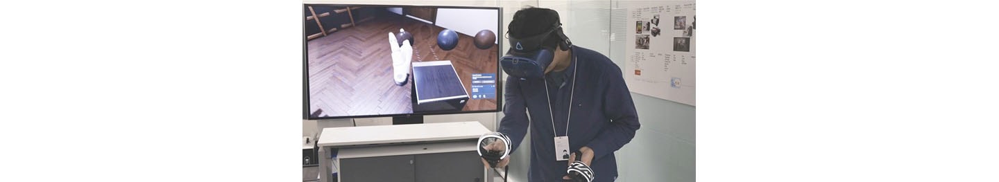One of LG’s digital designers using a VR headset and remote control to better understand a product’s ability to harmonize with the environment.
