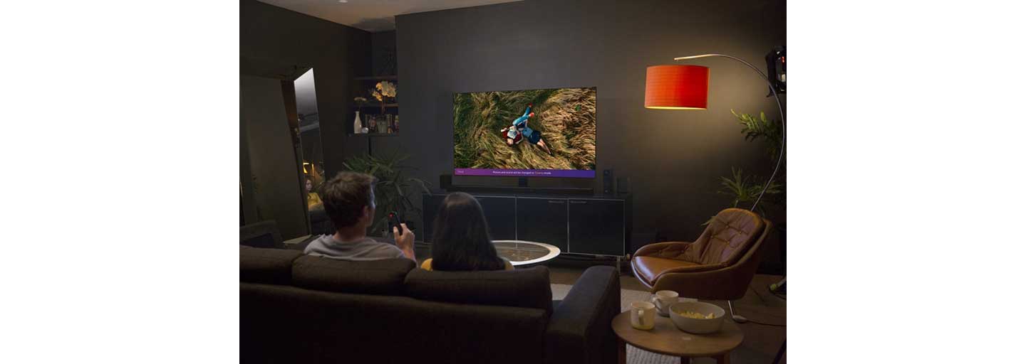 A couple watching a movie together on an LG TV.