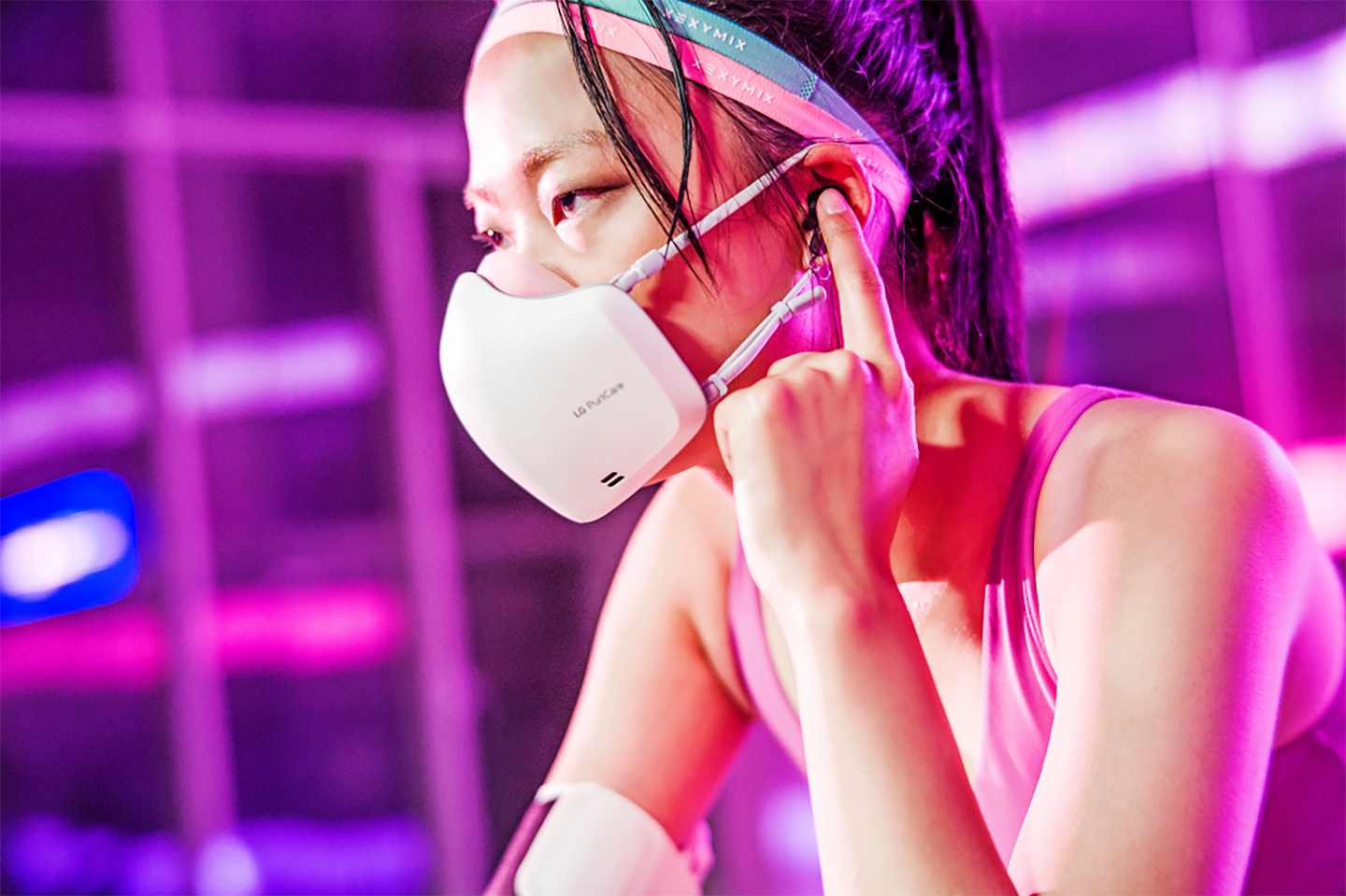 	 A woman wearing the newest LG PuriCare Wearable during a workout
