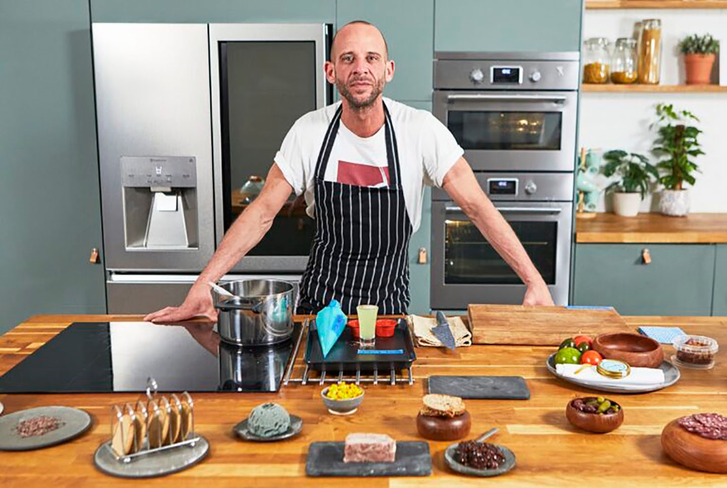 Chris Denny posing in the kitchen prepared to film LG SIGNATURE event